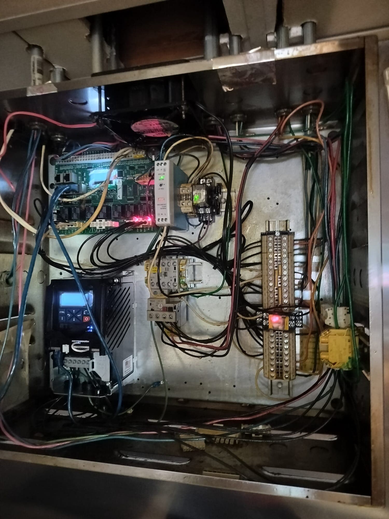 Electrician working inside a clean, labeled 200-amp residential electrical panel