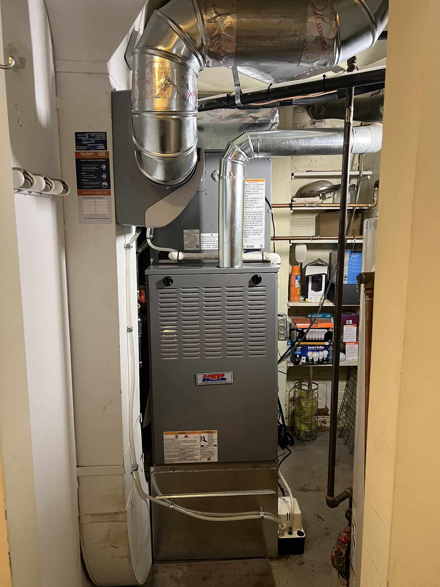 Technician installing a new high-efficiency furnace and AC condenser at a Glenview home