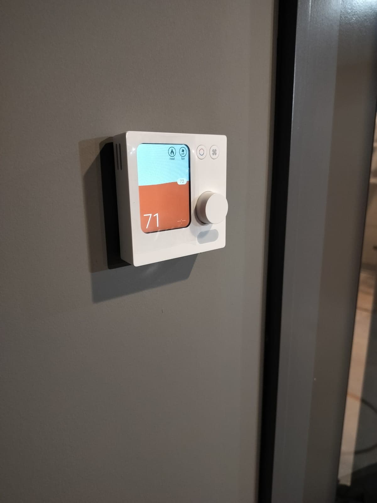 Smart thermostat set up by AMW during a seasonal HVAC maintenance visit